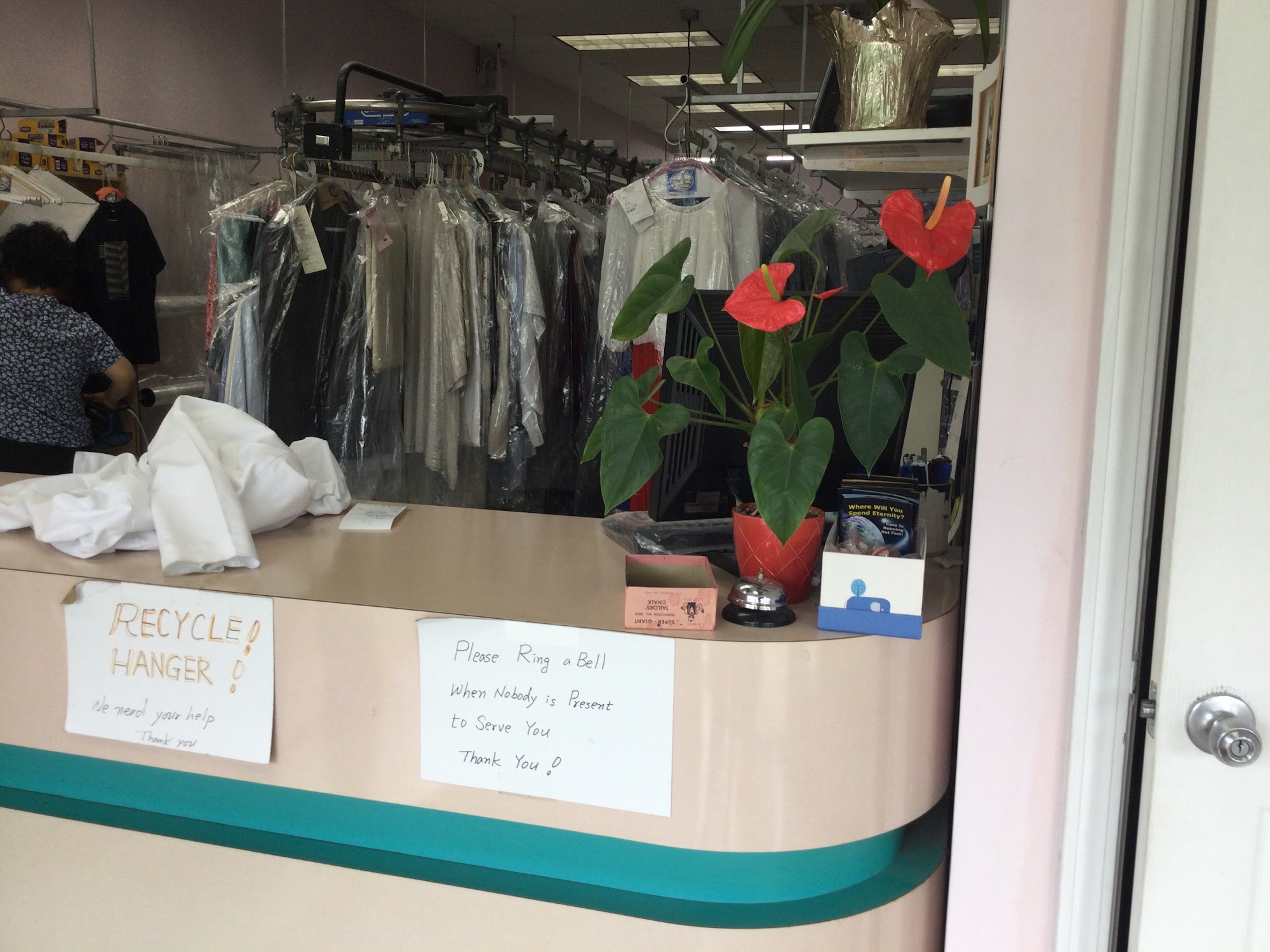 Inside Gage Cleaners, with clothing racks and the service counter